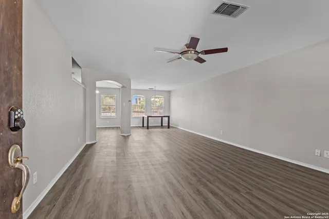 wooden floor in an empty room with a window