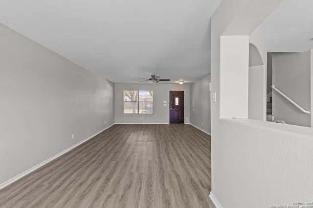 wooden floor in an empty room with a window