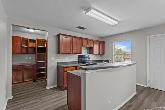 a kitchen with stainless steel appliances granite countertop a stove and cabinets