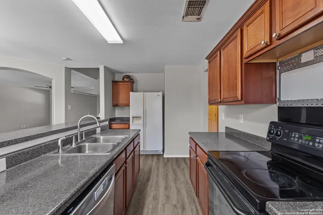 a kitchen with granite countertop a stove and a sink