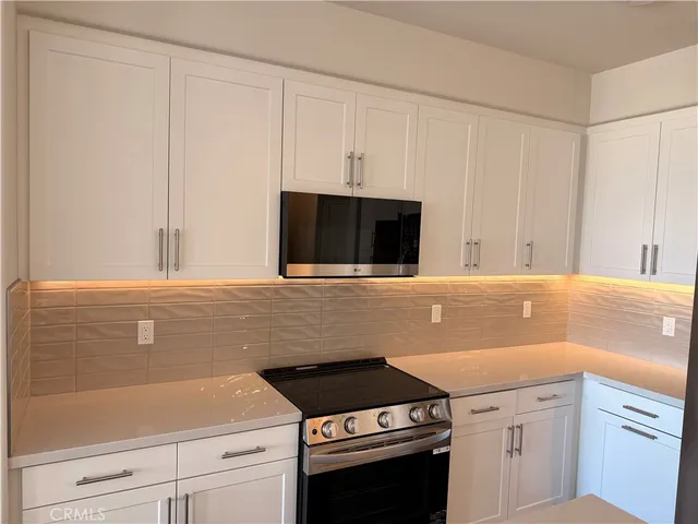 a kitchen with a stove and a microwave