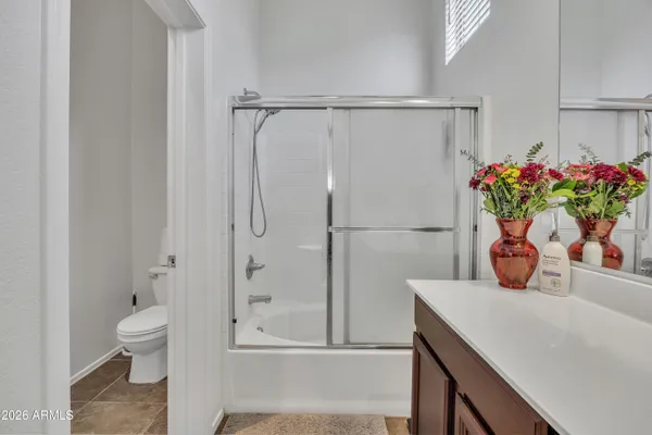 a bathroom with a shower toilet and sink