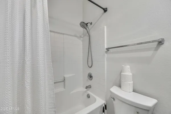 a bathroom with a toilet and shower
