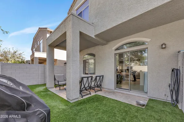 a view of a porch with chairs and backyard