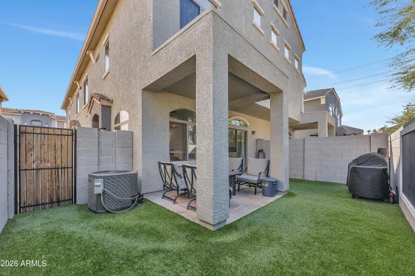 a view of a patio with furniture and a yard