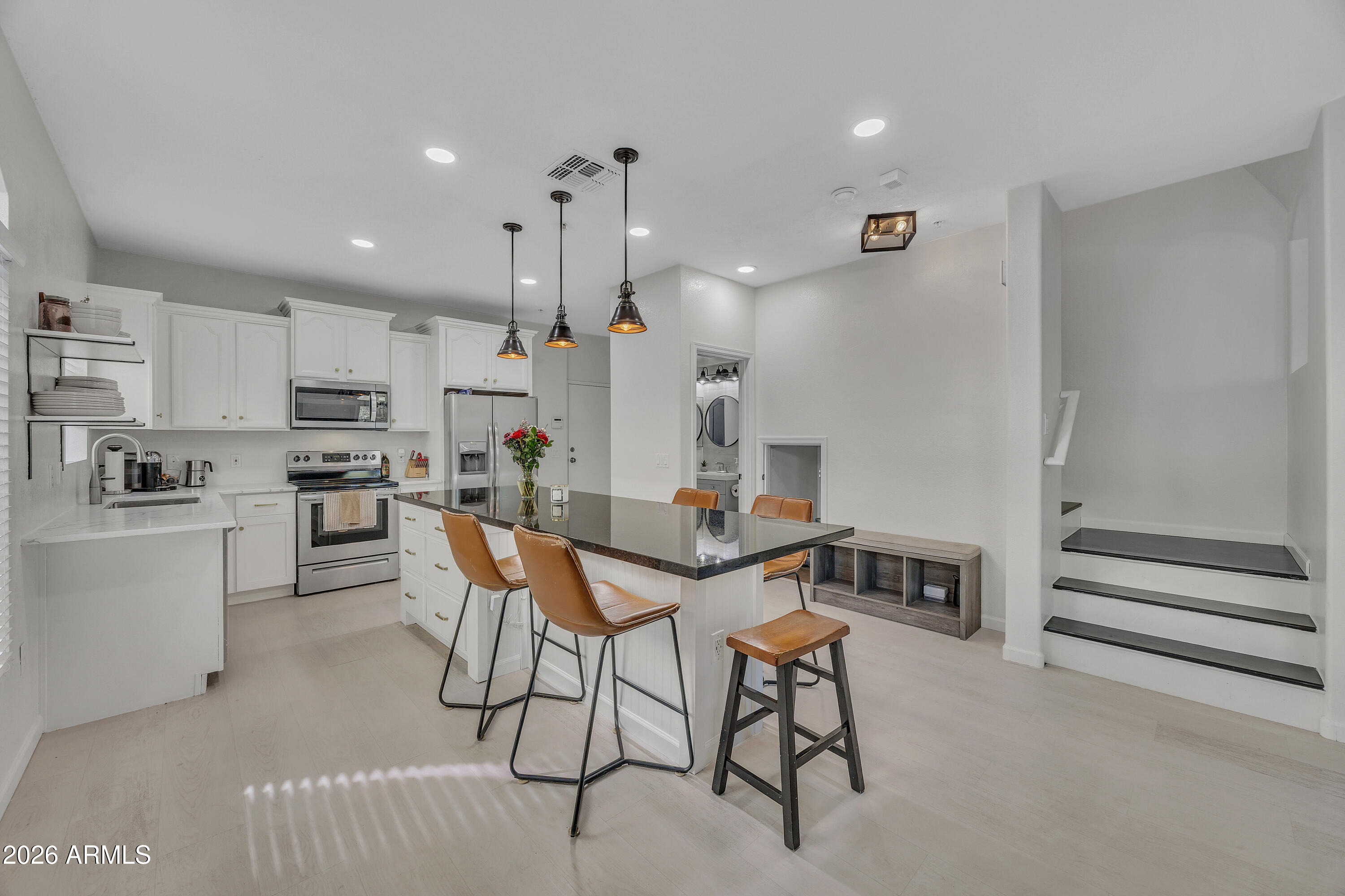 280 South Evergreen Road, Unit 1263 Tempe, AZ 85288 - Photo 2 of 32 a kitchen with stainless steel appliances kitchen island granite countertop a sink and cabinets