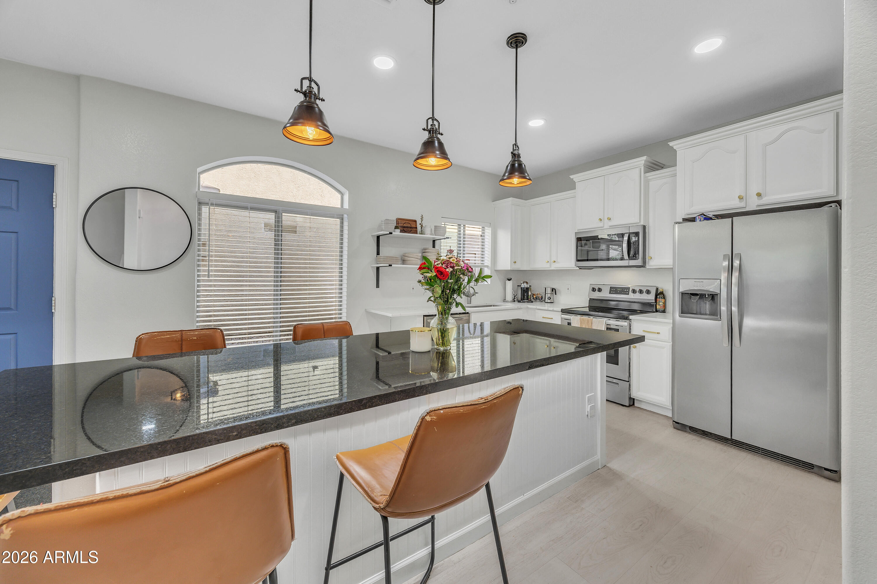 280 South Evergreen Road, Unit 1263 Tempe, AZ 85288 - Photo 7 of 32 a kitchen with stainless steel appliances granite countertop a sink a stove a refrigerator cabinets and chairs