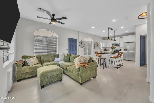 a living room with furniture and a chandelier