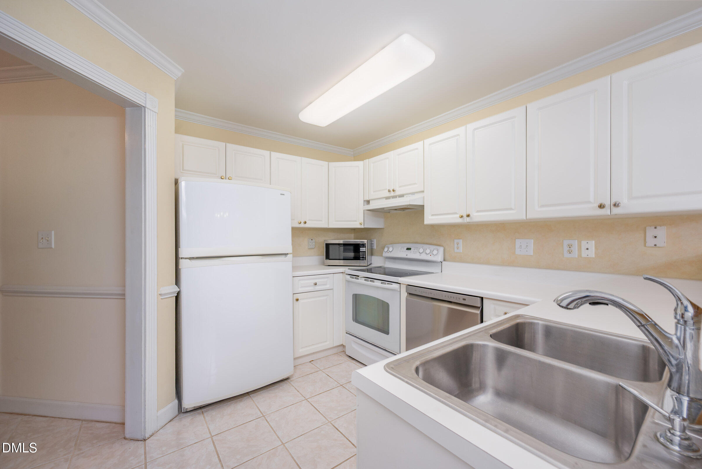 118 Grande Meadow Way Cary, NC 27513 - Photo 14 of 33 a kitchen with a refrigerator sink and white cabinets