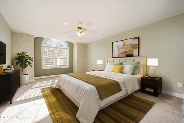a spacious bedroom with a bed and a chandelier