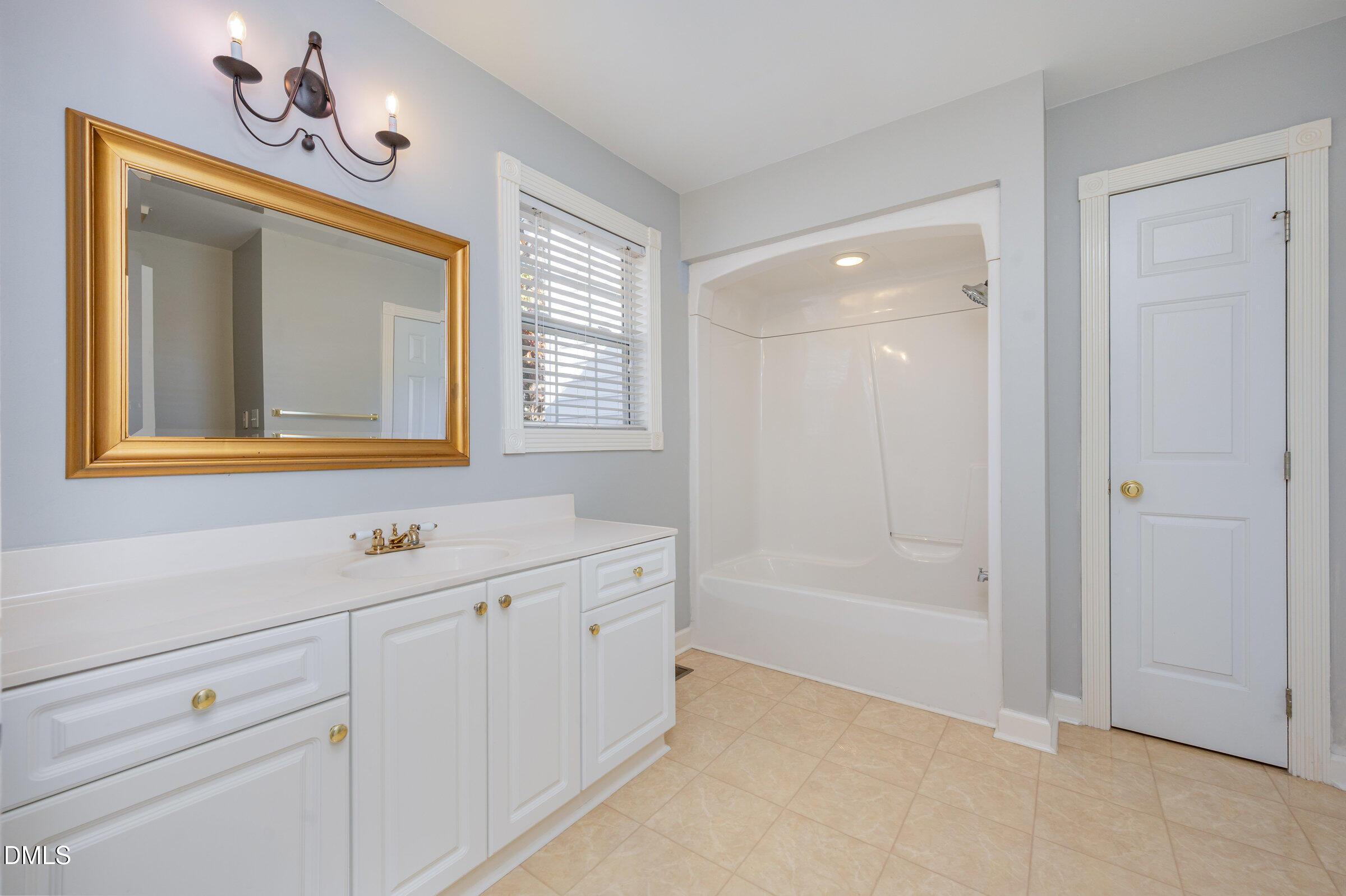118 Grande Meadow Way Cary, NC 27513 - Photo 26 of 33 a bathroom with a sink a mirror and a bathtub