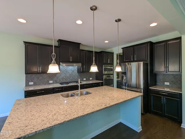 a kitchen with center island table and chairs
