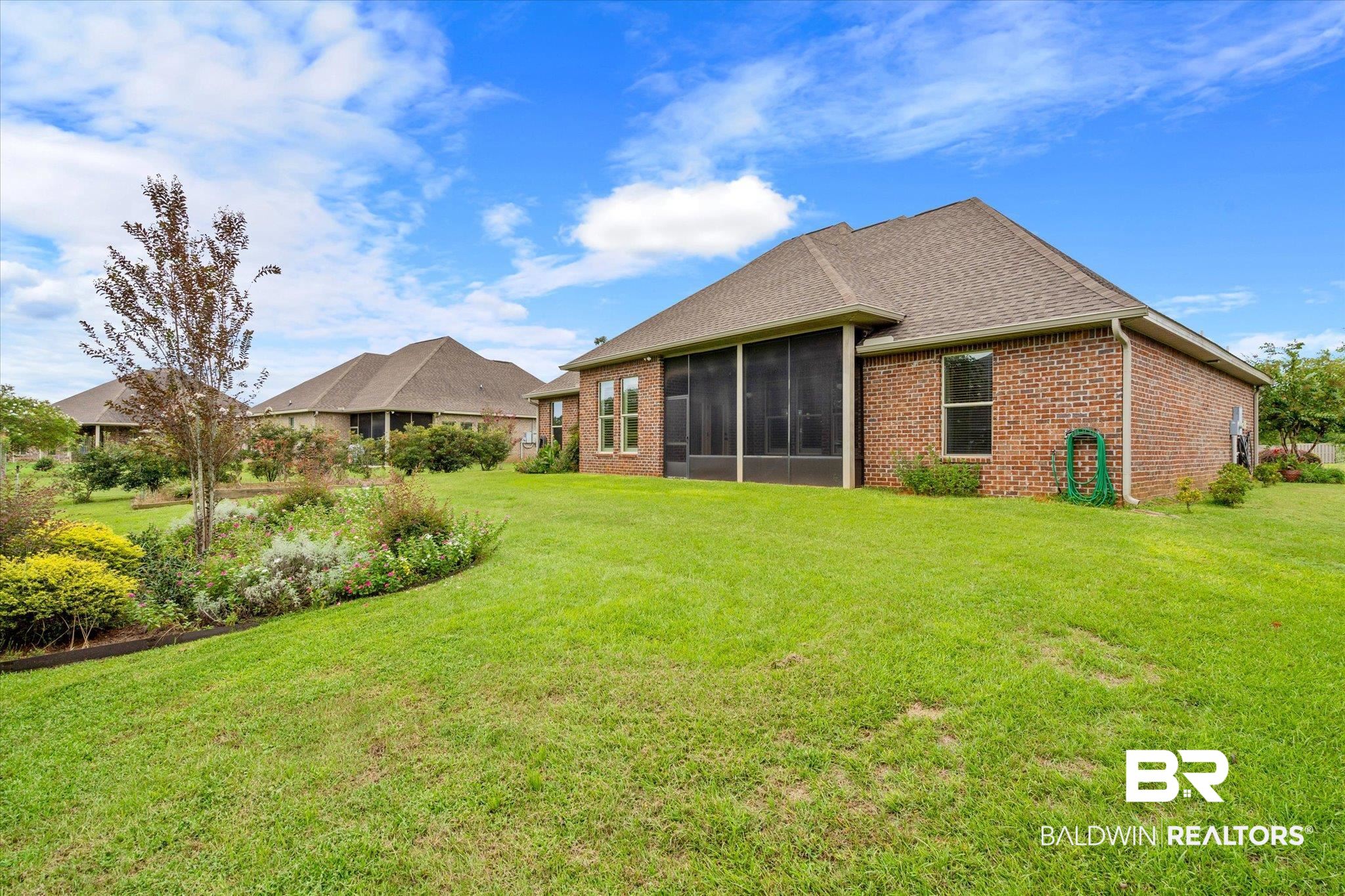 423 Breckin Drive Fairhope, AL 36532 - Photo 29 of 31 Back of property with a sunroom and a lawn