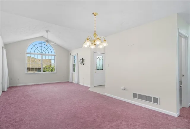 a kitchen with kitchen island white cabinets and stainless steel appliances