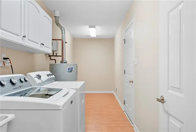 a utility room with dryer washer and a refrigerator