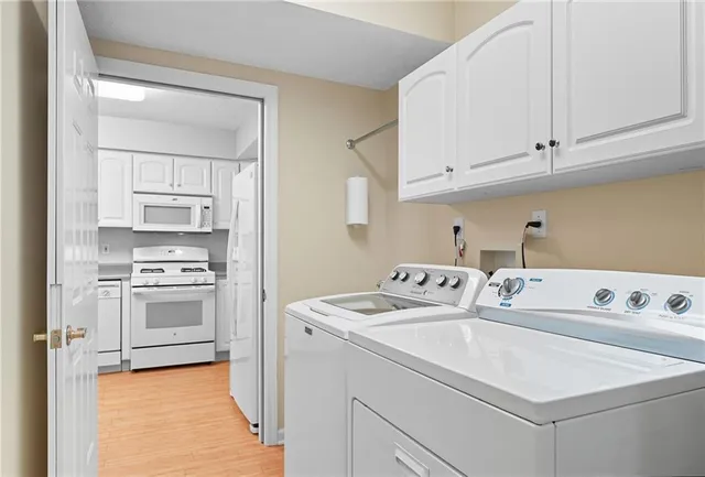 a bedroom with a large bed and a potted plant