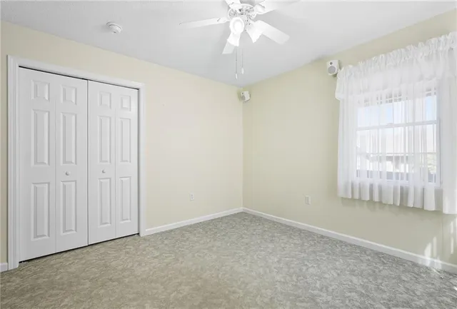 en empty room with fan and windows