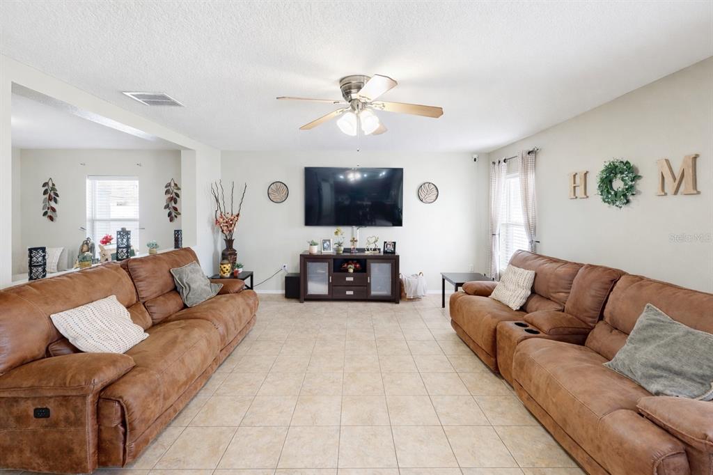 4354 Fieldview Circle Wesley Chapel, FL 33545 - Photo 3 of 15 a living room with furniture and a flat screen tv