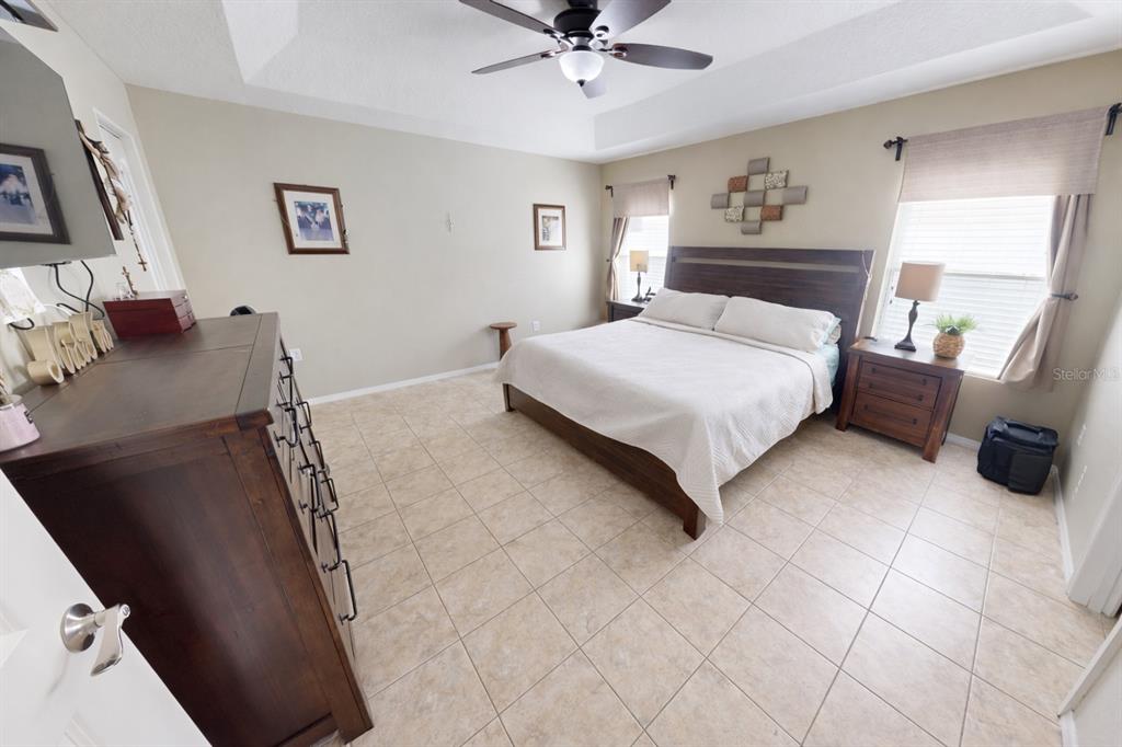 4354 Fieldview Circle Wesley Chapel, FL 33545 - Photo 9 of 15 a bedroom with a bed and a chandelier