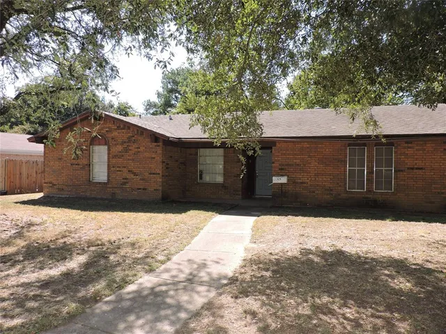 a front view of a house with a yard covered in snow