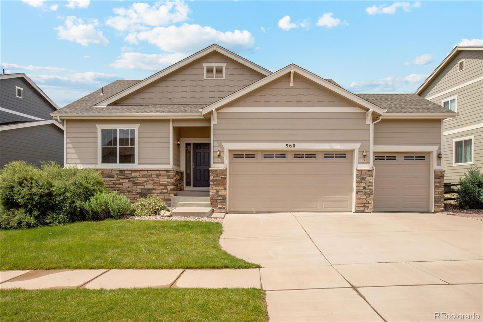 a front view of a house with a yard and garage