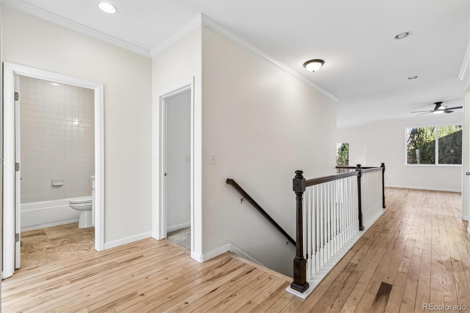 960 Fire Rock Place Colorado Springs, CO 80921 - Photo 2 of 32 a view of a hallway with wooden floor and stairs