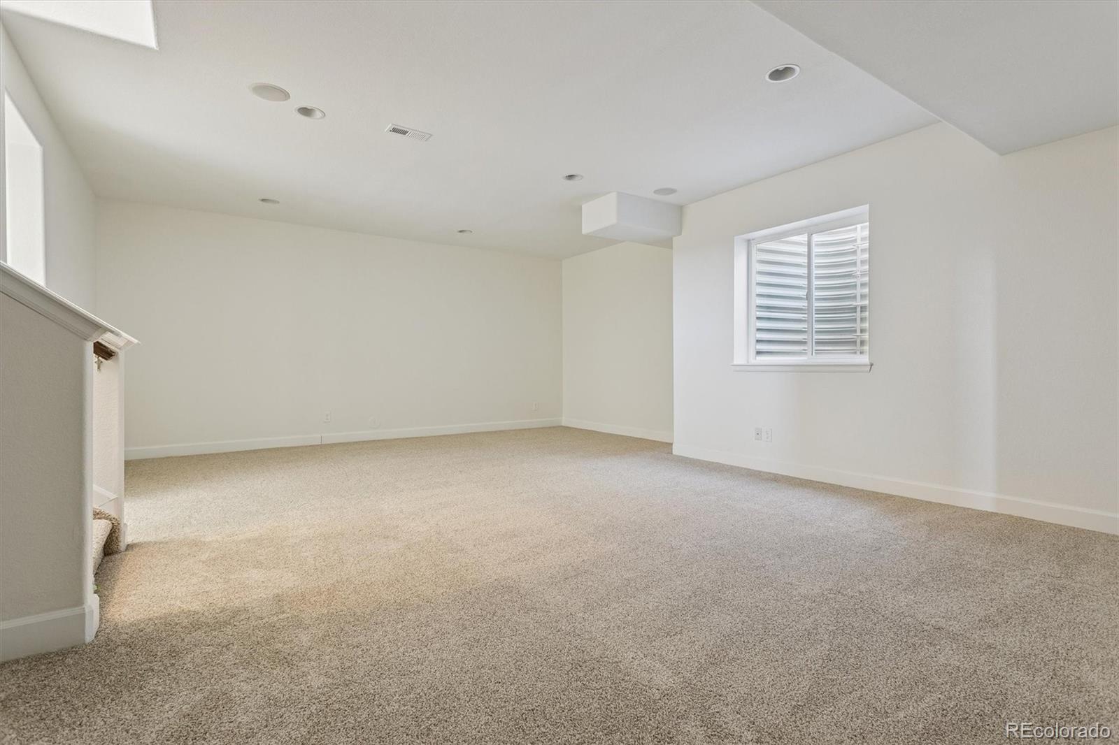 960 Fire Rock Place Colorado Springs, CO 80921 - Photo 23 of 32 an empty room with a windows and chandelier fan