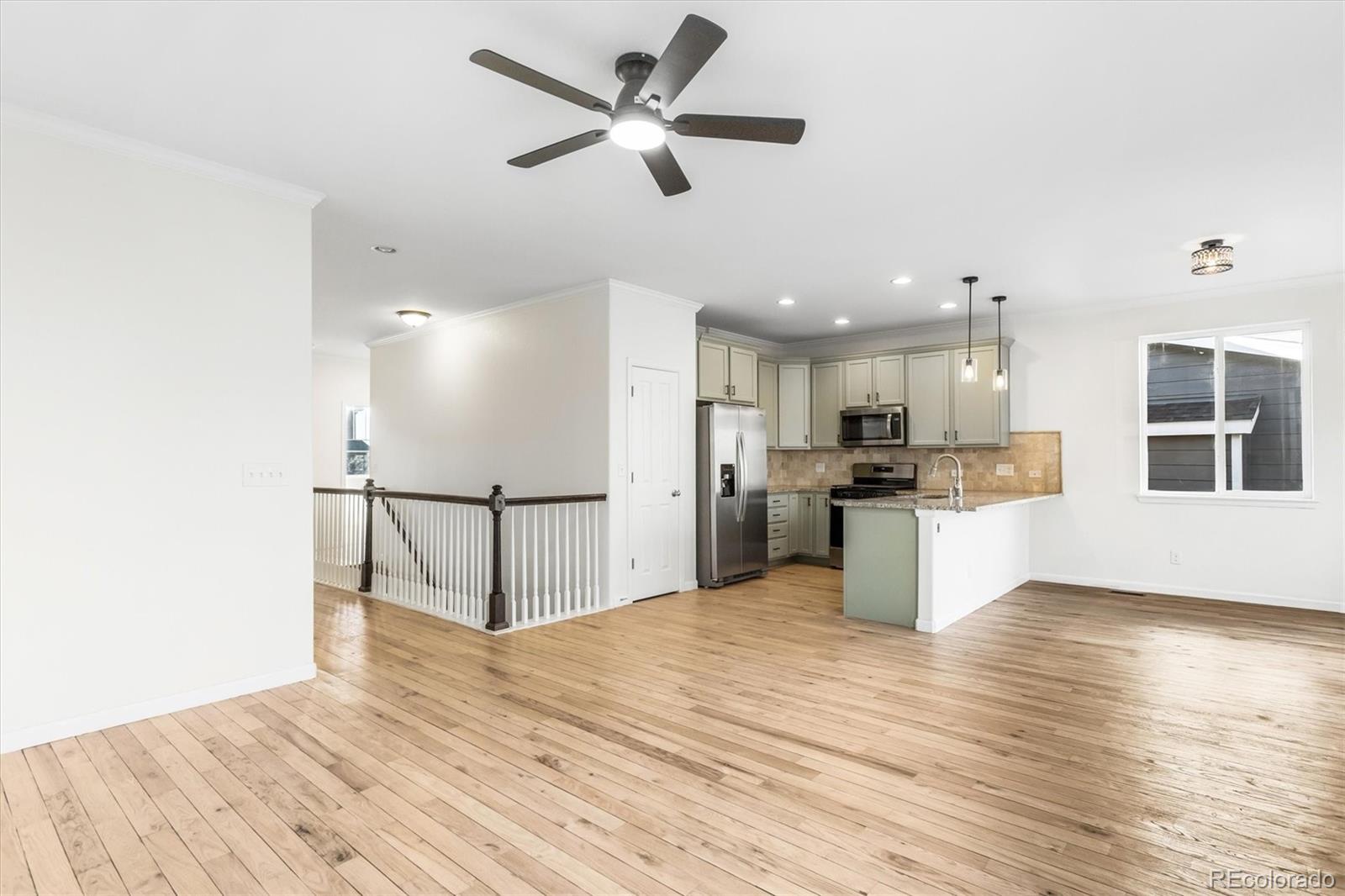 960 Fire Rock Place Colorado Springs, CO 80921 - Photo 4 of 32 a view of kitchen with refrigerator microwave and stove