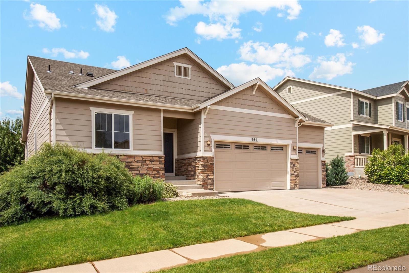 960 Fire Rock Place Colorado Springs, CO 80921 - Photo 5 of 32 a front view of a house with a yard and garage