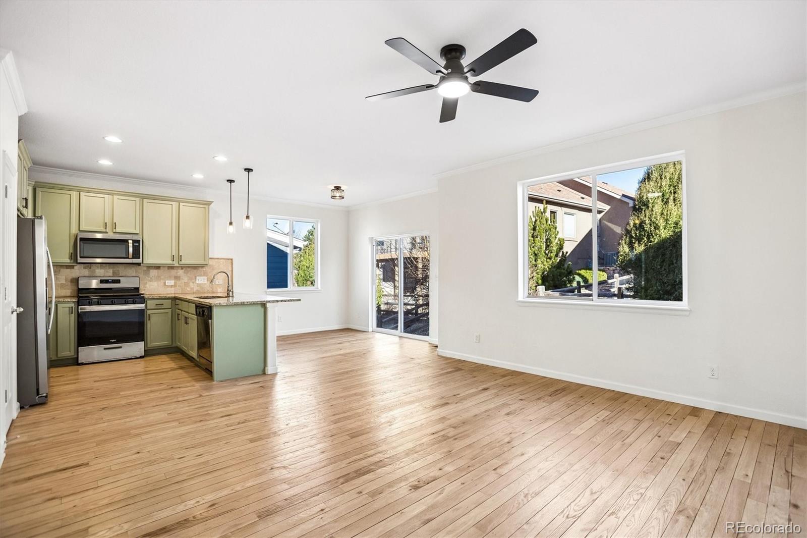 960 Fire Rock Place Colorado Springs, CO 80921 - Photo 6 of 32 a view of kitchen with cabinets and wooden floor