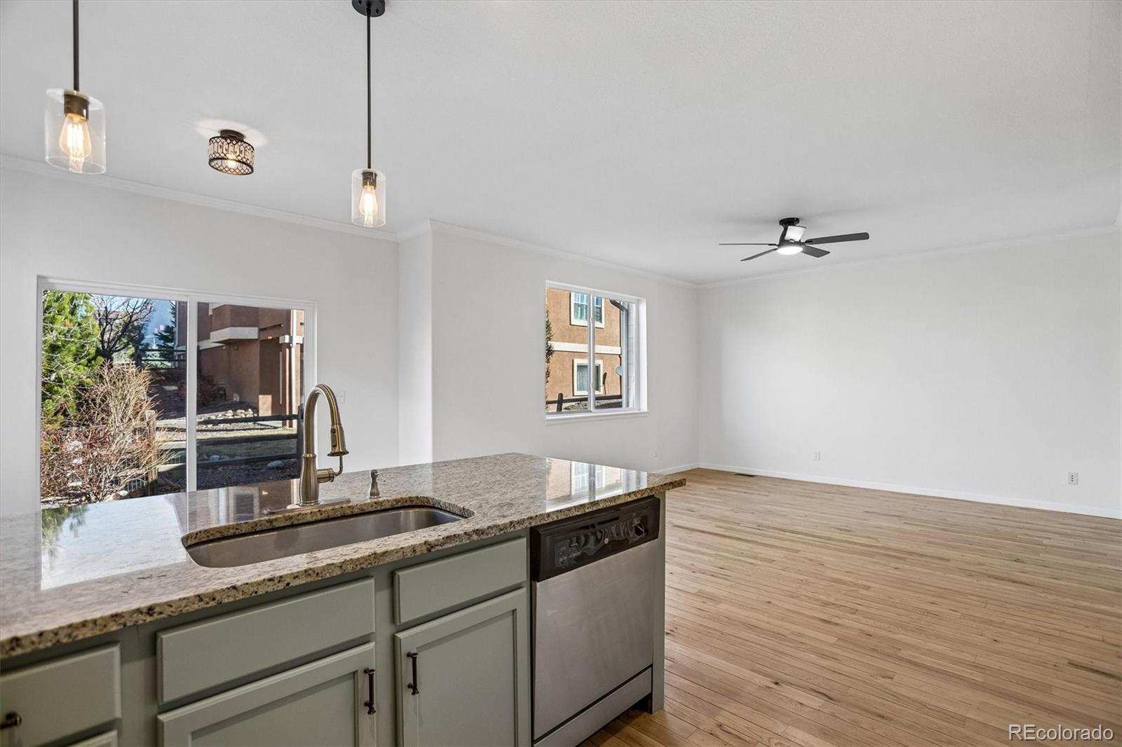960 Fire Rock Place Colorado Springs, CO 80921 - Photo 9 of 32 a kitchen with granite countertop a sink and a stove