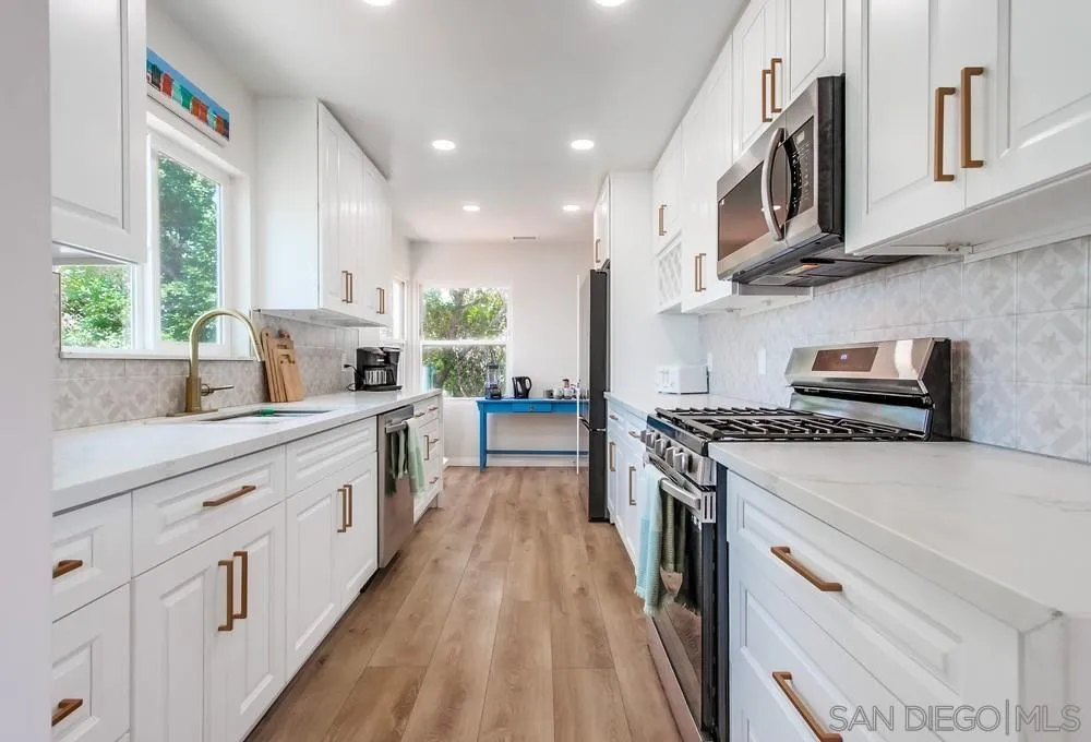 4724 Troy Lane La Mesa, CA 91942 - Photo 13 of 49 a kitchen with stainless steel appliances granite countertop a stove and a sink