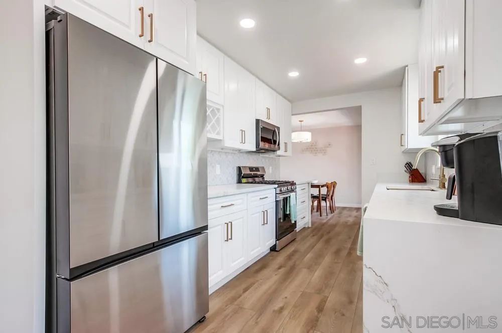 4724 Troy Lane La Mesa, CA 91942 - Photo 15 of 49 a kitchen with stainless steel appliances a refrigerator stove microwave and sink