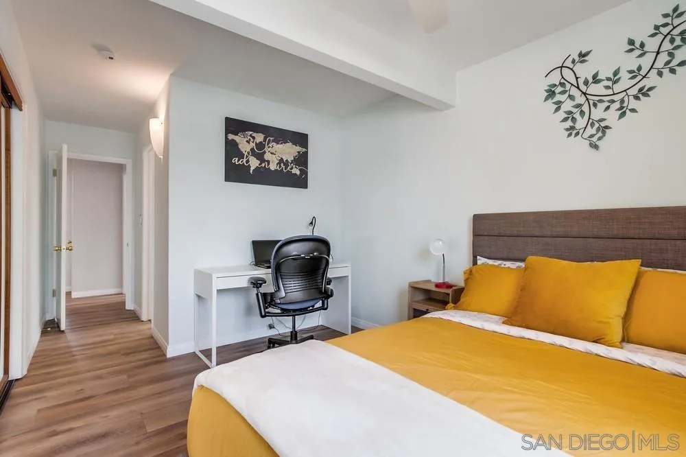 4724 Troy Lane La Mesa, CA 91942 - Photo 23 of 49 a bedroom with a bed and wooden floor