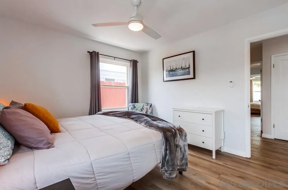 4724 Troy Lane La Mesa, CA 91942 - Photo 25 of 49 a bedroom with a bed and wooden floor