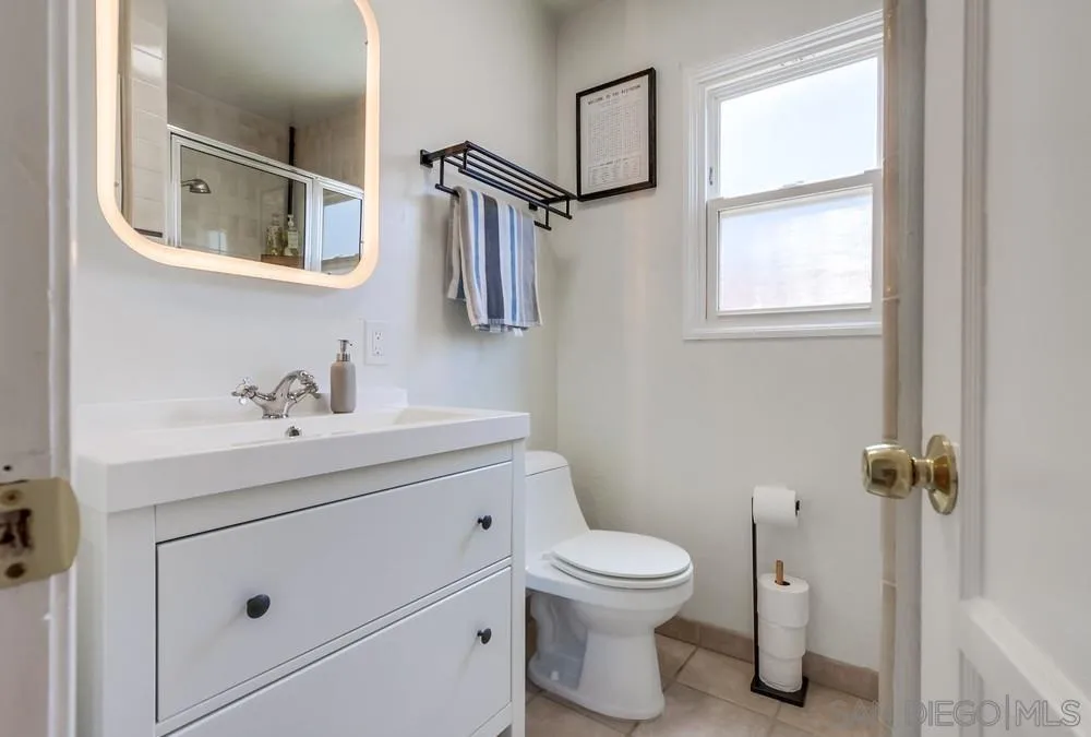 4724 Troy Lane La Mesa, CA 91942 - Photo 28 of 49 a bathroom with a toilet sink and mirror