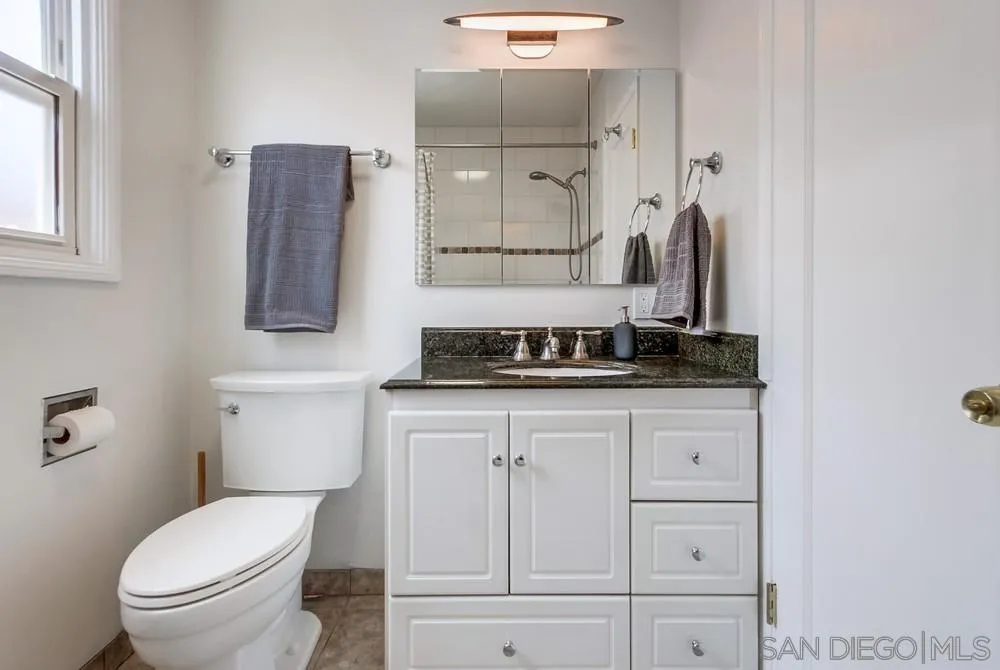 4724 Troy Lane La Mesa, CA 91942 - Photo 29 of 49 a bathroom with a toilet sink and vanity