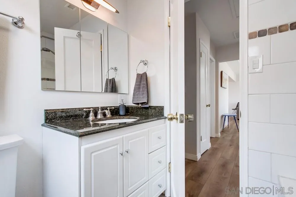 4724 Troy Lane La Mesa, CA 91942 - Photo 30 of 49 a bathroom with a sink and a mirror