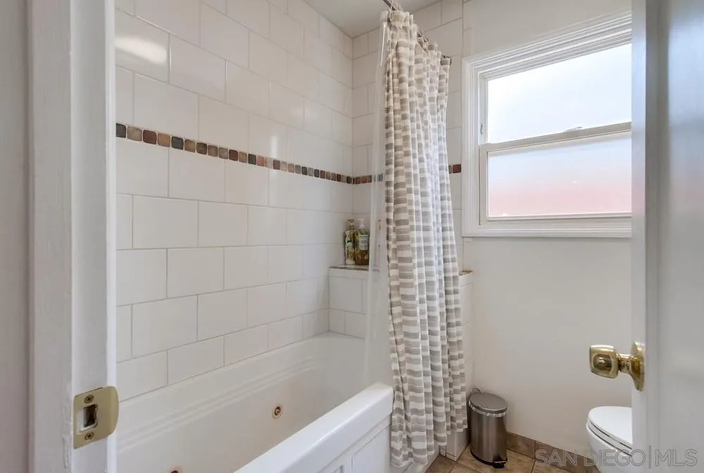 4724 Troy Lane La Mesa, CA 91942 - Photo 31 of 49 a bathroom with a shower curtain and a toilet