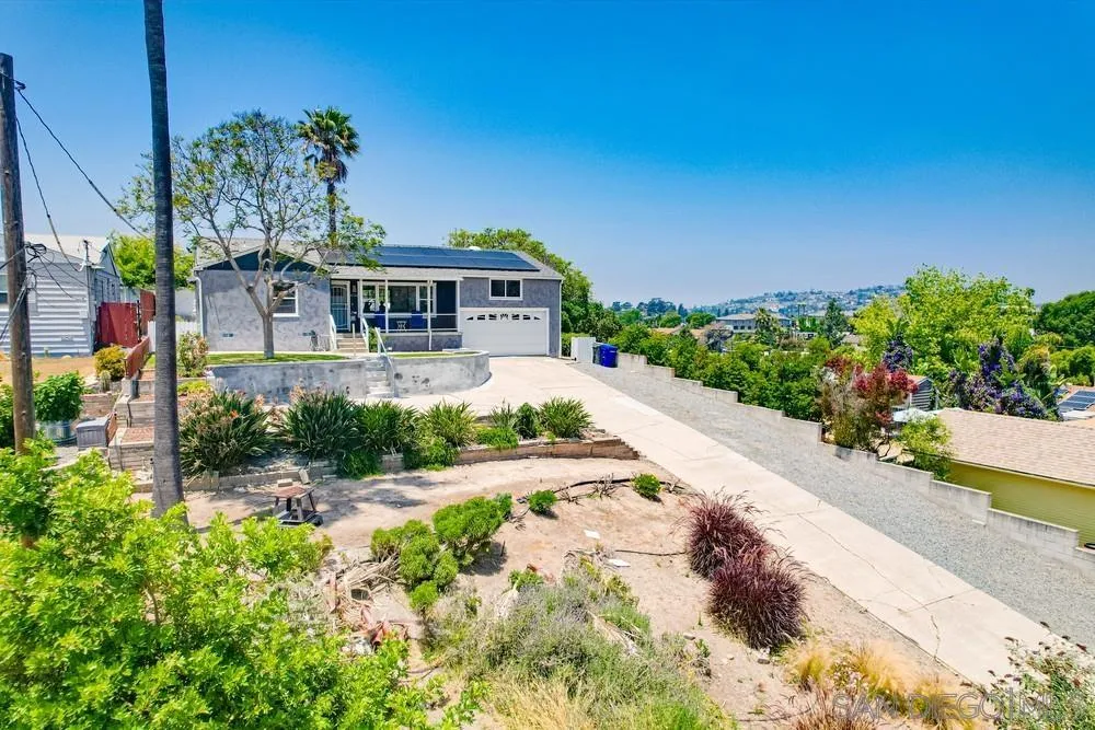 4724 Troy Lane La Mesa, CA 91942 - Photo 47 of 49 a front view of a house with a yard and potted plants