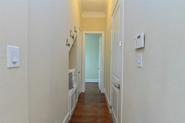 a view of a hallway with wooden floor and closet