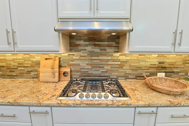 a kitchen with granite countertop stainless steel appliances and cabinets