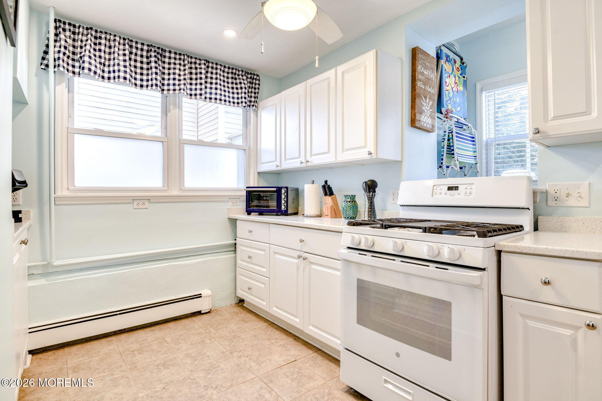 18 Abbott Avenue, Unit GARDEN Ocean Grove, NJ 07756 - Photo 12 of 16 a kitchen with granite countertop white cabinets and white appliances