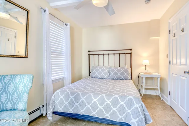 a bedroom with a large bed and a window