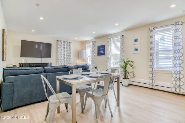 a view of a dining room with furniture and wooden floor