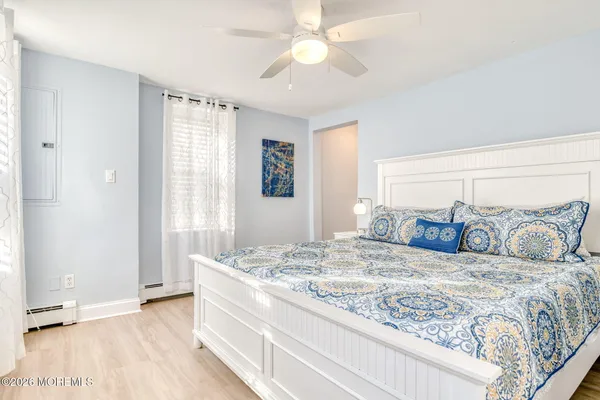a spacious bedroom with a large bed and a chandelier