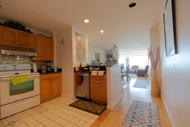 a kitchen with stainless steel appliances granite countertop a refrigerator a stove a sink and a microwave