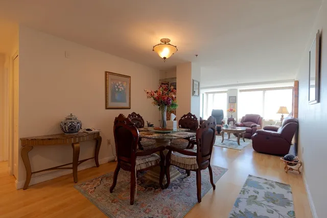 a living room with furniture a flat screen tv and a window