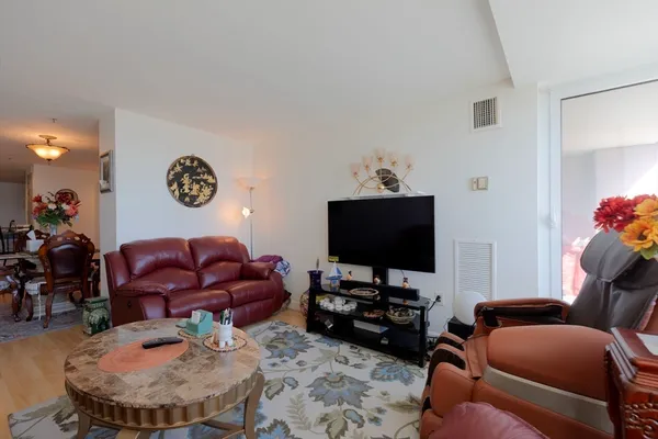 a view of a dining room with furniture and chandelier