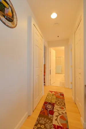 a hallway with a furniture and a rug